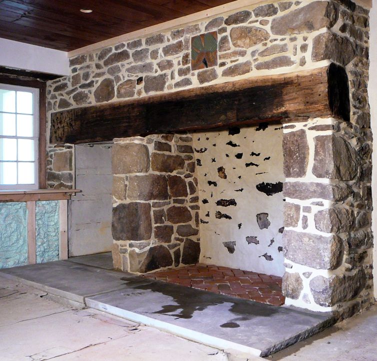 Stone fireplace with brick hearth and wood mantel