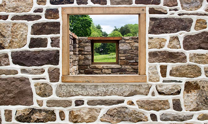 Close-up of window opening in stone foundation